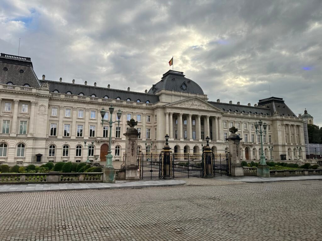 Großes historisches Gebäude mit heller Fassade unter bewölktem Himmel